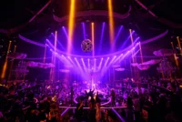 Dubai nightclub interior with DJ stage, lights, and crowd dancing — Dubai Party Life